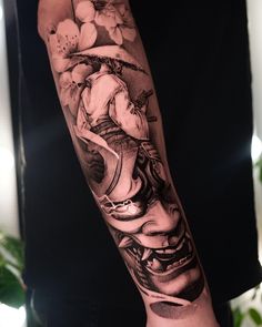 a person with a black and white tattoo on their arm