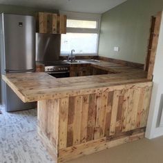 an unfinished kitchen counter made out of pallet wood