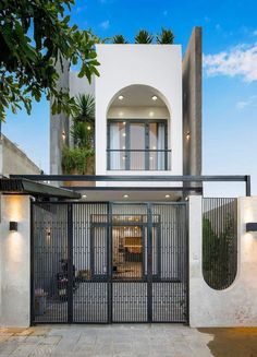 an entrance to a modern home with iron gates