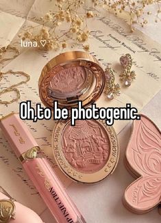 the words oh to be photogenic on top of some pink lipstick and other items