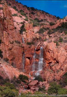 a large waterfall cascading into the side of a mountain