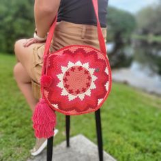 Crochet bag: Versatile crochet crossbody bag, that can be worn as a shoulder bag Lovingly crafted by the skilled artisans of the Wayuu tribe in La Guajira. Only one item is available for each design! Don't miss your favorite! - Versatile Style: This rounded bag easily converts from a crossbody to a shoulder bag, adapting to your needs effortlessly. - Lightweight and Sturdy: Enjoy the perfect balance of lightweight comfort and durability for all-day carrying convenience. - Handwoven Strap: The strap is hand-loomed, adding a touch of authenticity to your look. - Secure Your Belongings: Inside, you'll find a metal lock to keep your essentials safe and sound. - Adorable Pompom: We've included a cute, removable pompom to add a playful touch. Approximate Dimensions: - Circumference: 10.23 inches Crochet Crossbody Bag, Wayuu Bag, Versatile Style, Bag Shoulder, Crochet Bag, Purses And Handbags, Halloween Shopping, Shoulder Bags, Crossbody Bag