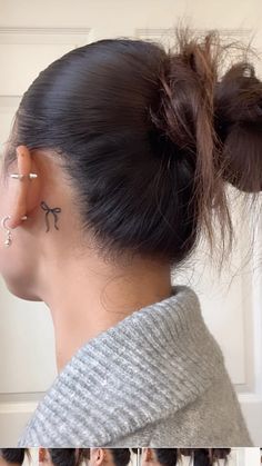 an image of a woman with ear piercings on her ears and behind her ear