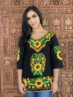 This Beautiful Mexican blouse is embroidered on an artisanal Machine using Silk Thread. It has beautiful sunflowers embroidered both on the front and also on the sleeves. This Blouse is truly a work of art and one of a kind. Yellow Long Sleeve Tops With Sunflower Print, Yellow Long Sleeve Top With Sunflower Print, Yellow Floral Embroidery Blouse For Vacation, Fitted Yellow Tops With Sunflower Print, Bohemian Yellow Blouse With Floral Embroidery, Yellow Bohemian Embroidered Top With Floral Design, Yellow Bohemian Embroidered Top With Floral Embroidery, Yellow Bohemian Top With Floral Embroidery, Mother's Day Promotion