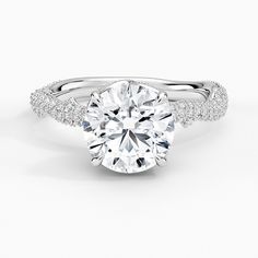 a round cut diamond ring with pave set shoulders