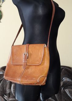 "Vintage cognac brown Cristian italian cognac Brown Florence Leather crossbody bag/shoulder bag. Footed rustic boho handBag with Shoulder Strap. Inside 1 zip compartment. Magnetic frontal closure. Inside bag cover has cracks - look at the photo. Inside brown textile lining. From 1970s. Adjustable strap. Inside label with inscription: Cristian, Florence leather, made in Italy. brand: Cristian. condition: The purse has many streaks/scratches on the surface. Shabby purse. Measurements: height 20,5 Luxury Vintage Cognac Shoulder Bag, Distressed Brown Crossbody Shoulder Bag For Travel, Rustic Crossbody Bag For Everyday Use, Vintage Cognac Satchel With Adjustable Strap, Vintage Brown Crossbody Satchel With Adjustable Strap, Vintage Brown Crossbody Saddle Bag With Adjustable Strap, Vintage Brown Saddle Shoulder Bag With Adjustable Strap, Brown Saddle Satchel With Adjustable Strap, Rustic Brown Bags With Leather Lining