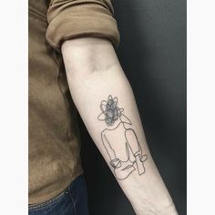 a person with a tattoo on their arm holding onto the arm of another person's arm