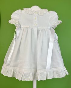 A traditional and cute dress for baby girls to wear on a special day. It is made with english muslin and cotton laces. It has buttons on the back for closure and comes with a matching bonnet. Made in Spain Inside: 65% polyester 35% cotton Dry Clean Final sale, no exchanges nor returns are accepted Classic Broderie Anglaise Dresses For Daywear, Classic Broderie Anglaise Dresses For Daytime, Classic Dresses With Broderie Anglaise For Daywear, Fitted Cotton Baptism Dress With Ruffles, Classic Cotton Dress With Lace Collar, Elegant Cotton Baptism Dress With Broderie Anglaise, Fitted Cotton Baptism Dress With Lace Trim, Classic Ruffled Dresses For Dress-up, Classic Ruffled Dresses For Dress-up Occasions