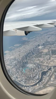 an airplane window looking out at the city below