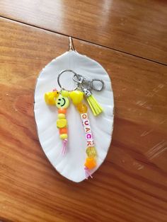 a paper plate with some plastic items on it and a keychain attached to it