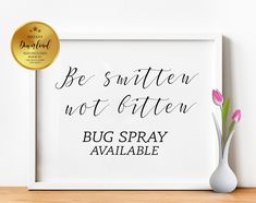 a white framed print with the words be smitter not bitten, bug spray available