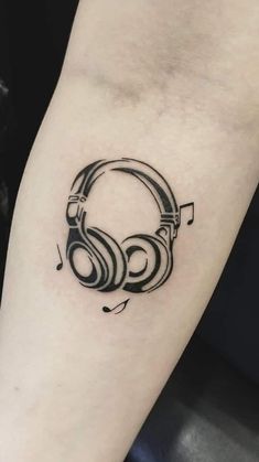 a tattoo with headphones and music notes on it