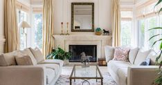 a living room with two couches and a coffee table in front of a fireplace