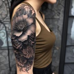 a woman with a black and white flower tattoo on her arm