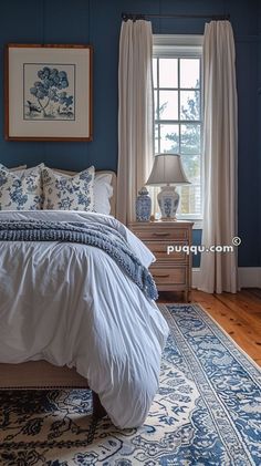 a bedroom with blue walls and white bedding