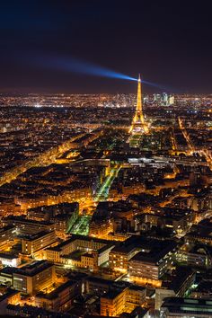 the eiffel tower lit up at night in paris, france as seen from the top of the eiffel tower