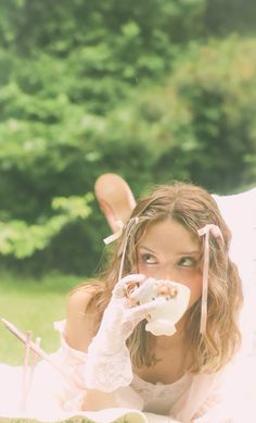 a woman laying on the ground eating food