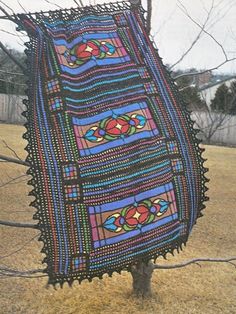 an old photo of a blanket hanging from a tree