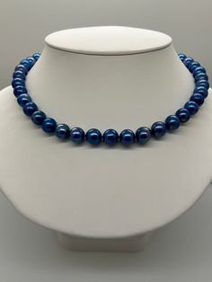 Royal Blue Freshwater Pearl Necklace. This hand knotted necklace features 37 Royal Blue Freshwater Pearls AA+ High Luster Round to Near Round Bead Nucleated 10.2 to 11.5mm some surface blemishes and swirls in the nacre. Please enlarge the photos for details.  These Pearls are Genuine and they are color enhanced.  I hand knotted these with royal blue silk thread and finished them with a 925 S Vintage Swarovski Crystal Blue Bow Tie Box clasp 10 X 45mm.  The necklace measures 19 inches in length.  The necklace pictured is the one you will receive.   They will arrive in a nice presentation box with a Certificate of Authenticity.  Please visit our shop for more pearls and gemstone jewelry. Elegant Royal Blue Round Beads Necklace, Elegant Royal Blue Round Bead Necklaces, Elegant Royal Blue Round Beaded Necklace, Elegant Blue Necklace With 8mm Beads, Elegant Blue Necklaces With 8mm Beads, Classic Blue Round Beads Jewelry, Elegant Blue Necklace With Round Beads, Classic Blue Round Bead Jewelry, Elegant Blue Pearl Necklace With Gemstone Beads