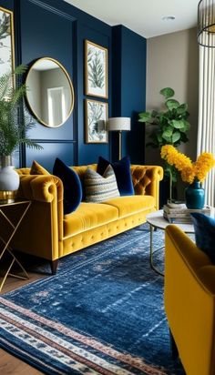 a living room with blue walls, yellow couches and gold mirrors on the wall