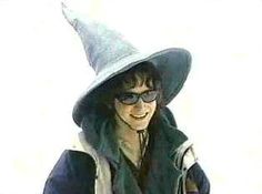 a woman wearing a witches hat and sunglasses