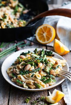 a white plate topped with pasta and vegetables