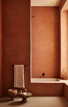 a bath room with a toilet and a bath tub next to a window on the wall