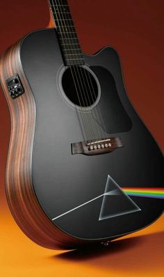 the dark side of the moon guitar is shown with a rainbow triangle sticker on it