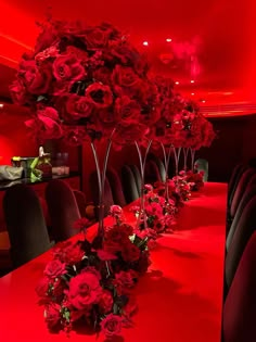 a long table with red flowers on it