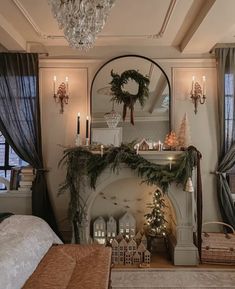 a living room filled with furniture and a fire place covered in christmas greenery next to a fireplace