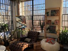 a living room filled with furniture and lots of windows