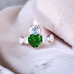 Cat Lover Gift Novelty Ring Women Green Emerald Ring Silver Kitty Ring Kitty Inspired Ring Animal Lover Jewelry Japanese Cartoon Heart Rings Welcome to Shreenathjewelry JUST OPENED- Experience beautiful jewelry that complements your everyday style, and completes your look. Our jewelry is so stunning, and so you are. Ring description Primary Stone:- Emerald (Lab Created) Stone Shape:- Heart Stone Color:- Green Stone Size: 6mm Jewelry Type: Stacking Ring  Method: Cast Personalization: Possible Occasion: Engagement Ring Size: We make rings from US 4 to US 10. (If you need smaller or bigger ring size, please ask me to resize) Country of Manufacture: India All our work is custom made by hand with Love and Care in our workshop ♥ CUSTOM ORDERS Please let us know if you want any customization or p Emerald Ring Silver, Jewelry Japanese, Smaragd Ring, Heart Rings, Lover Jewelry, Cartoon Heart, Green Emerald Ring, Heart Stone, Cat Ring