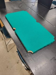 a table with a green cloth on top of it