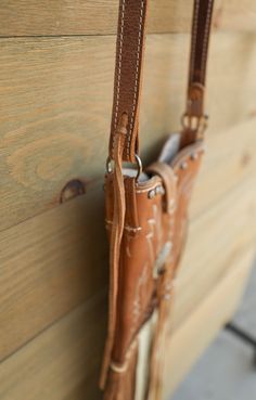 Fort Benton Boot Crossbody Bag Looking for something unique ... well here it is! The Fort Benton Boot Crossbody Bag is handcrafted in Texas, U.S.A. This one of a kind leather bag is made from recycled cowboy boots! Features cream stitched brown leather uppers adorned with buckle and leather accent, leather strap with magnetic closure, leather horse reins as strap, and brown and cream hand stitched leather fringe. This Western bag is the perfect size to hold your phone, small wallet, and a few es Country Style Brown Bag For Everyday Use, Western Leather Shoulder Bag For Everyday Use, Brown Leather Bags For Rodeo, Western Style Leather Shoulder Bag For Everyday Use, Hand Tooled Brown Bags For Rodeo, Brown Hand Tooled Bag For Rodeo, Hand Tooled Brown Bag For Rodeo, Western Leather Bags For Rodeo, Hand Tooled Leather Bags For Rodeo