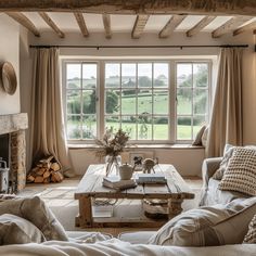 a living room filled with furniture and a fire place in front of a large window