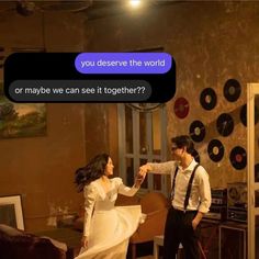 a man and woman dancing in a room with records on the wall