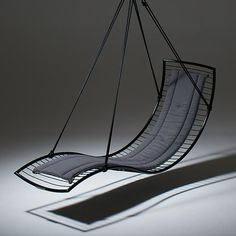 a hanging chair that is shaped like a boat