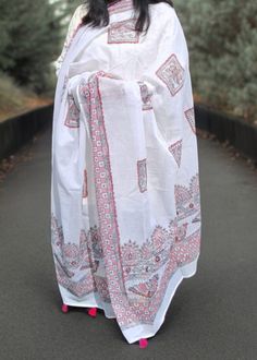 A white mulmul cotton dupatta adorned with Black Red Madhubani painting featuring geometric pattern , shankh and floral design is a masterpiece of traditional Indian artistry and craftsmanship. The soft , lightweight fabric of mulmul cotton ensures comfort and ease of wearing, while the Madhubani painting, a folk art style from Bihar , India , adds a burst of color and intricate detailing. The painting typically features motifs inspired by nature , mythology, and daily life , meticulously hand-painted using vibrant natural dyes. Each dupatta is a unique piece , showcasing the skill and creativity of the artisan , making it not just a garment accessory but a beautiful cultural expression. Bohemian Cambric Dupatta For Festive Occasions, Bohemian Mulmul Kurta With Dupatta, Traditional Drape Dupatta With Printed Motifs In Mulmul, Bohemian Chanderi Kurta With Printed Border, Bohemian Mulmul Dupatta With Chikankari Embroidery, Bohemian White Dupatta With Printed Motifs, Bohemian Dupatta With Chikankari Embroidery, Festive White Dupatta With Printed Motifs, Cotton Kurta With Dupatta For Puja