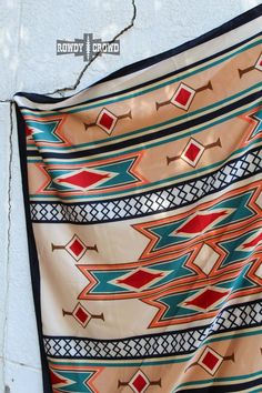 Measures 36" x 36" 100% Polyester material The Huckleberry Wild Rag has a bright and eye-catching Aztec print! On a cream base, with tan, red, orange, and turquoise Aztecs in the pattern. This wild rag has a soft silky like feel and can be worn normally, as a head scarf or top! Aztec Print Scarf, Cream Base, Wild Rag, Orange And Turquoise, Aztec Pattern, Aztec Print, Unique Charms, Head Scarf, All Seasons