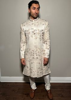 Featuring an ivory hand embroidered sherwani with all over tone-on-tone applique flowers. Paired with matching pintuck kurta and churidar. Bandhani Jacket, Crystal Blouse, Kali Lehenga, Fish Cut, Kurta Pants, Raw Silk Lehenga, Organza Lehenga, Sharara Gharara, Lehenga Collection