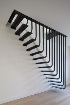 a black and white staircase in an empty room