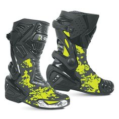 a pair of black and yellow motorcycle boots on a white background with paint splatters