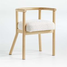 a wooden chair with a white cushion on it