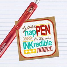 a red pen sitting on top of a piece of paper next to a notepad