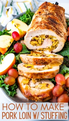 a white plate topped with sliced pork and salad next to apples, grapes and oranges