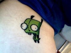 a small cartoon character tattoo on the thigh