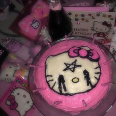 a hello kitty birthday cake on a table