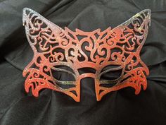 This hand-drawn designed 3d printed mask is great for Halloween, masquerade parties, renaissance fairs or just your own fun photoshoot! It's lightweight, comfortable and formed to the face. Just a touch of spirit gum keeps it in place (not included) or a ribbon tie (included.)  Available in matte, gloss, glitter, red & black, orange & black (pictured above), white & black (for an arctic fox look) or any combination of crazy colors you want. Handmade Masquerade Mask For Halloween Cosplay, Gothic Masquerade Mask For Carnival Festival, Handmade Fantasy Halloween Mask, Adjustable Fantasy Masks And Prosthetics For Events, Handmade Halloween Festival Masquerade Mask, Fantasy Halloween Masks, Themed Mask Costume Accessories For Fantasy Events, Themed Mask For Fantasy Events, Themed Costume Mask For Fantasy Events