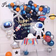 an astronaut themed birthday party with balloons and decorations