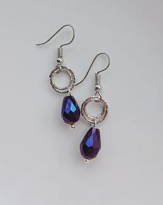 Handmade earrings with alloy material ear hooks. Two silver textured rings and dark purple teardrop beads. Drop Length from bottom of the hook: 24mm. Available in any colour on request. Purple Teardrop Metal Earrings, Purple Teardrop Metal Jewelry, Purple Metal Earrings With Dangling Beads, Purple Dangle Teardrop Earrings With Ear Wire, Purple Nickel-free Teardrop Dangle Earrings, Purple Teardrop Jewelry With Dangling Beads, Hypoallergenic Purple Dangle Teardrop Earrings, Commission Ideas, Earrings Handmade Dangle